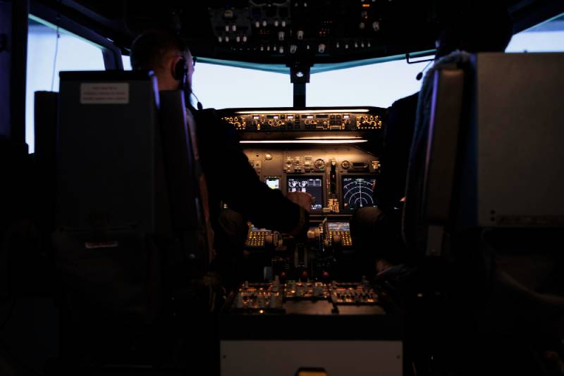 The cockpit of a modern fighter jet with advanced digital displays.
