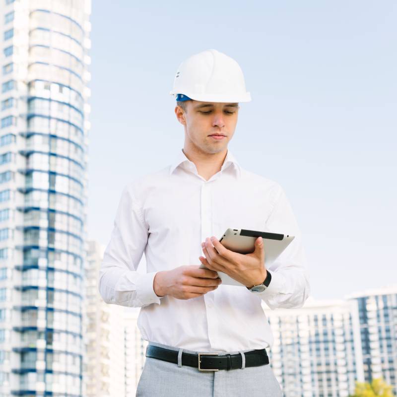 Engineers using a tablet with a conversational AI to solve a problem.